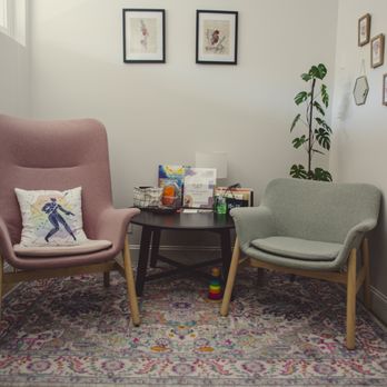 Wolff Osteopathic Medicine - Two chairs pink and pale green with a colorful accent pillow on a colorful rug a physician's waiting room - Osteopathic Physicians Near Me - San Francisco, California Wolff Osteopathic Medicine - Two chairs pink and pale green with a colorful accent pillow on a colorful rug a physician's waiting room - Osteopathic Physicians Near Me - San Francisco, California