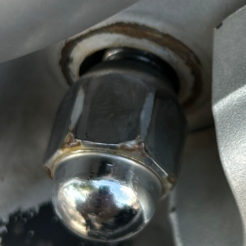 Brake Masters - Damaged lug bolt. The lug nut is fully screwed on, and you can see the bolt drooping. - Auto Repair Near Me - Tempe, Arizona Brake Masters - Damaged lug bolt. The lug nut is fully screwed on, and you can see the bolt drooping. - Auto Repair Near Me - Tempe, Arizona