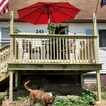 SkyLine Renovations & Remodeling - a dog in front of a house with an umbrella - General Contractors Near Me SkyLine Renovations & Remodeling - a dog in front of a house with an umbrella - General Contractors Near Me