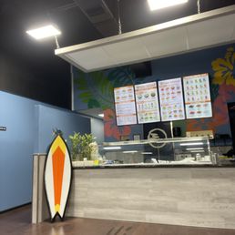 a surfboard leaning against the counter a surfboard leaning against the counter