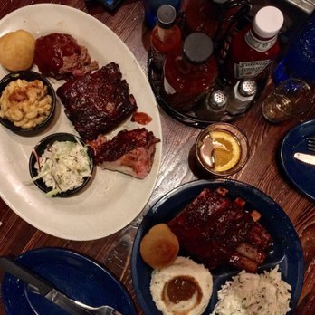 Dinosaur Bar-B-Que - Two combination platters: Left: pulled pork, ribs, chicken Right: ribs, pork belly - Barbeque Near Me - Brooklyn, New York Dinosaur Bar-B-Que - Two combination platters: Left: pulled pork, ribs, chicken Right: ribs, pork belly - Barbeque Near Me - Brooklyn, New York
