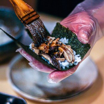 Maki By Akimori - a person holding a piece of food - Kosher Near Me - Brooklyn, New York Maki By Akimori - a person holding a piece of food - Kosher Near Me - Brooklyn, New York