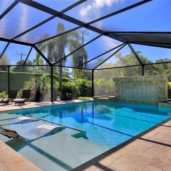 Nassau Pools Construction - Sun shelf with loungers & large waterfall feature - Pool & Hot Tub Service Near Me - Naples, Florida