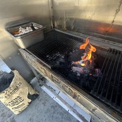 Los 3 Pollos - Plastic trash being burned while raw chicken is out in the open. Plastic will be exposed into the chicken.