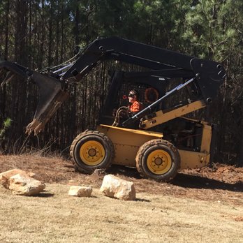 A & B Landscaping - a man operating a skid steer loader - Tree Services Near Me - Fayetteville, Georgia A & B Landscaping - a man operating a skid steer loader - Tree Services Near Me - Fayetteville, Georgia