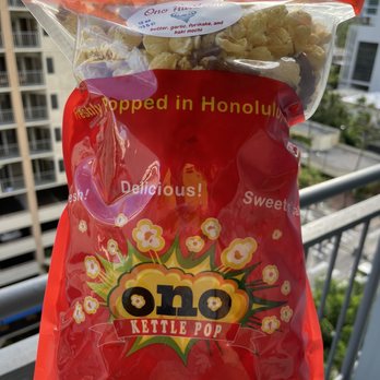 Ono Kettle Pop - a hand holding a bag of popcorn - Food Stands Near Me