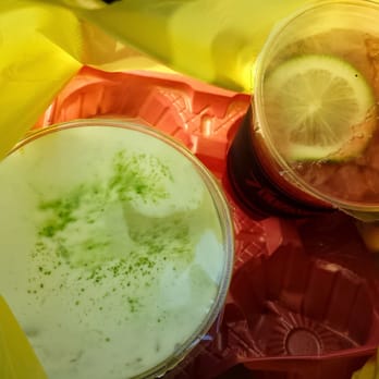 Photo of 7 Leaves Cafe - Garden Grove, CA, United States. Sea cream jasmine green tea and strawberry hibiscus tea in a plastic tray, all inside a plastic bag. Funny packaging, yo.