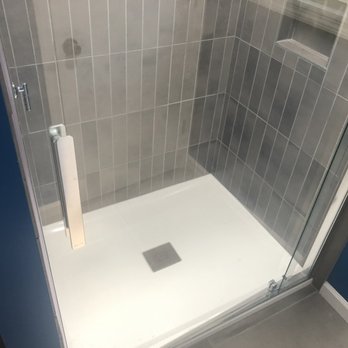 Solberg Builders - a shower with a glass door - General Contractors Near Me