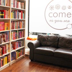 Inside the shop. Couch and our curated book selection.