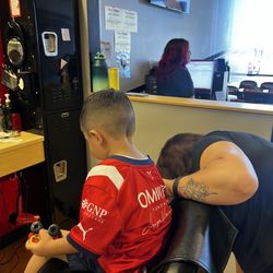 Sport Clips Haircuts of Hobbs - My son in the barber chair with Amanda after getting a fresh cut