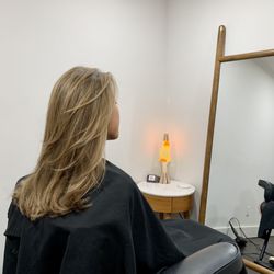 Salon Sovay - Stylist Sovay's client has naturally very dark brown/almost black hair. We shift/lift her base and tons of highlights. Long layered haircut.
