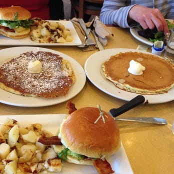 First Watch - 2 elevated egg sandwiches, carrot cake and plain pancakes, and ham and cheese omelette in the background. - Breakfast & Brunch Near Me - Orlando, Florida First Watch - 2 elevated egg sandwiches, carrot cake and plain pancakes, and ham and cheese omelette in the background. - Breakfast & Brunch Near Me - Orlando, Florida