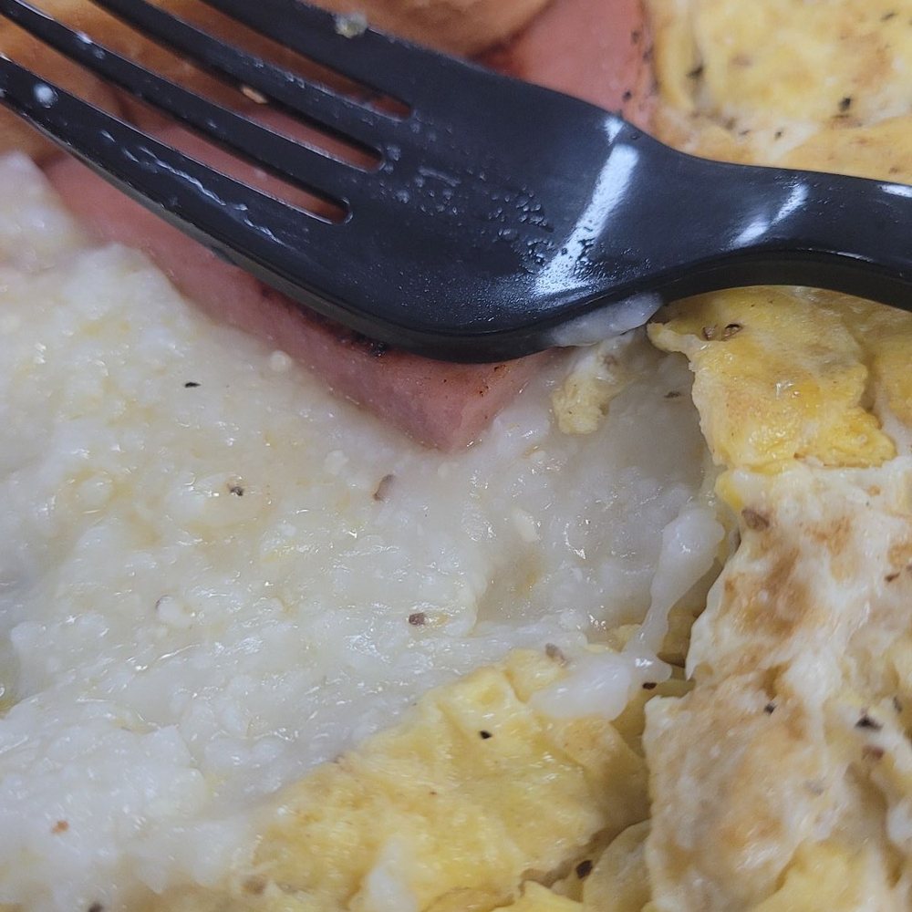 Scrambled eggs, grits, toast and bologna. Scrambled eggs, grits, toast and bologna.