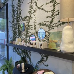 SALT - Mirrors, lighting, candles and oils. Live ivy-like plant growing up the wall indoors is a unique design element