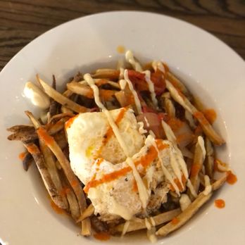 Bica Cafe - Portuguese Fries (hand cut fries topped with two over-medium eggs, Portuguese brown sauce, roasted red peppers, garlic aioli, and piri piri - Bakeries Near Me - Noblesville, Indiana Bica Cafe - Portuguese Fries (hand cut fries topped with two over-medium eggs, Portuguese brown sauce, roasted red peppers, garlic aioli, and piri piri - Bakeries Near Me - Noblesville, Indiana
