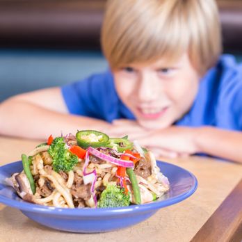 Mongo's Grill - a boy sitting at a table with a plate of food - Mongolian Near Me - Winnipeg, Manitoba Mongo's Grill - a boy sitting at a table with a plate of food - Mongolian Near Me - Winnipeg, Manitoba