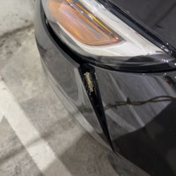 Avis Rent A Car - Driver's side front bumper showing collision damage.
