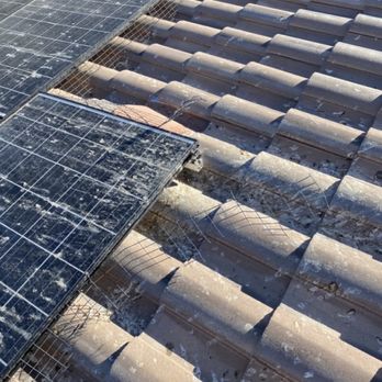 Purple Pest Solutions - Old screen that pigeons pulled away from solar panels - Pest Control Near Me Purple Pest Solutions - Old screen that pigeons pulled away from solar panels - Pest Control Near Me