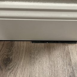 Poorly cut flooring that was not hidden behind the baseboard Poorly cut flooring that was not hidden behind the baseboard