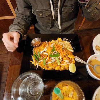 Thai Lotus - a man sitting at a table with a plate of food - Thai Near Me - Reno, Nevada Thai Lotus - a man sitting at a table with a plate of food - Thai Near Me - Reno, Nevada