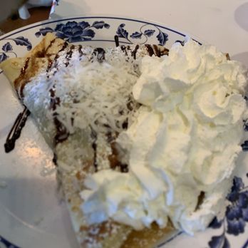 Caffe Torino - The Capri bananas, dark chocolate, topped with drizzle chocolate, shredded Coconut and whipped cream. - Cafes Near Me - Farmington, Utah