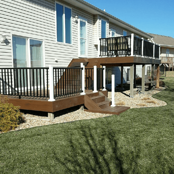 Green's Home Improvement - a back yard with a deck - Decks & Railing Near Me