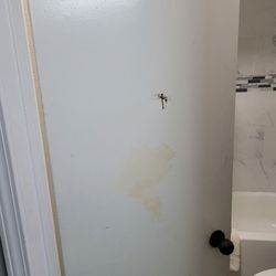 Motel 6 - Someone punched the bathroom door and there is a huge stain on it.