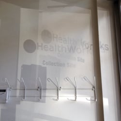 Concentra - Tacoma - Reflection US HEALTHWORKS GLASS DOOR SIGNAGE SHADOW ON WALL