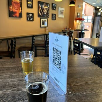 Midnight Oil Brewing Company - two glasses of beer on a table - Beer Tours Near Me - Newark, Delaware Midnight Oil Brewing Company - two glasses of beer on a table - Beer Tours Near Me - Newark, Delaware