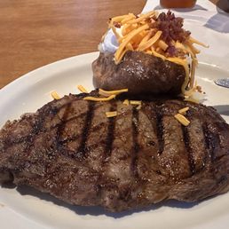 Ft Worth 14 oz ribeye with a baked potato. Ft Worth 14 oz ribeye with a baked potato.