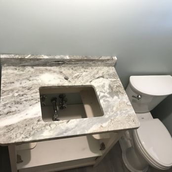 Bella Stone - a bathroom with a marble sink and toilet - Building Supplies Near Me - South Euclid, Ohio