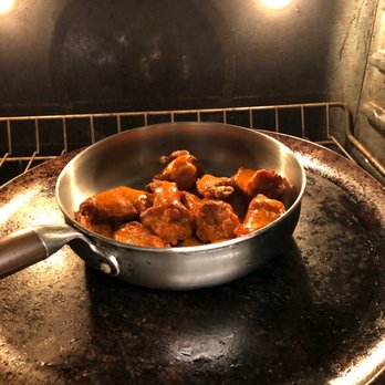 Wingstop - a pan of food cooking in an oven - Chicken Wings Near Me - Stone Mountain, Georgia