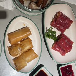Red rice noodles, fried spring roll with egg white and shrimp filling, pork spareribs and chicken feet rice bowl.