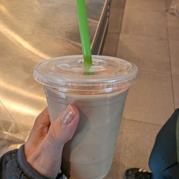 a hand holding a drink