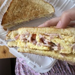 Egg sandwich with provolone cheese, red peppers, and ham Egg sandwich with provolone cheese, red peppers, and ham