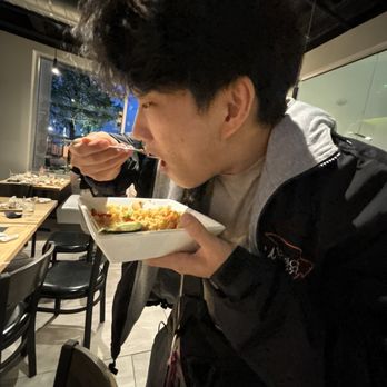 Bonchon Midtown Houston - one of our members munching on the delicious fried rice (soy garlic) - Korean Near Me - Houston, Texas