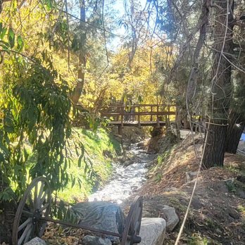 Riley's Farm - Bridge over the stream.  Axe throwing, archery and candle dipping on the other side. - Fruits & Veggies Near Me - Oak Glen, California