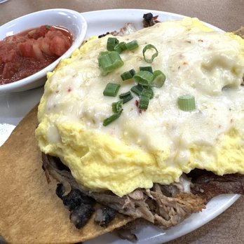 Fat Nat's Eggs - Huevos Rancheros Carnitas -- crispy tortillas stacked with eggs, tender carnitas, zesty ranchero sauce & all the fixings. - New American Near Me - St. Anthony, Minnesota Fat Nat's Eggs - Huevos Rancheros Carnitas -- crispy tortillas stacked with eggs, tender carnitas, zesty ranchero sauce & all the fixings. - New American Near Me - St. Anthony, Minnesota