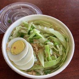 Chicken mami -- noodle soup with cabbage and hard boiled egg on top