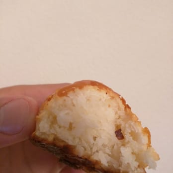 Danny Macaroons - a hand holding a half eaten macaroon - Macarons Near Me - New York, New York
