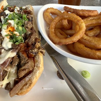 Yard House - Spicy Korean BBQ Cheesesteak with Beer-Battered Onion Rings - Bars Near Me - Temecula, California
