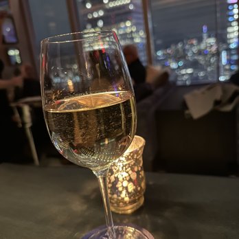 Bar 54 - Wine and view from table along the wall.  You can also be seated in a couch/booth along the outside window - Cocktail Bars Near Me - New York, New York