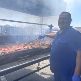 Proprietor grilling up a large batch of Carne Asada