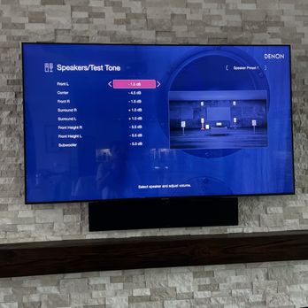 Universe - TV with center channel mounted to bottom of TV on jagged stone fireplace. - Home Theatre Installation Near Me Universe - TV with center channel mounted to bottom of TV on jagged stone fireplace. - Home Theatre Installation Near Me