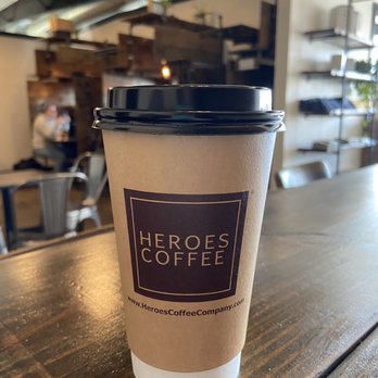 Heroes Coffee - a cup of coffee on a table - Coffee Roasteries Near Me - Bentonville, Arkansas