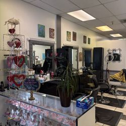 Close-up of styling stations and mirrors, showcasing a well-equipped workspace with quality tools and a relaxed, local feel.