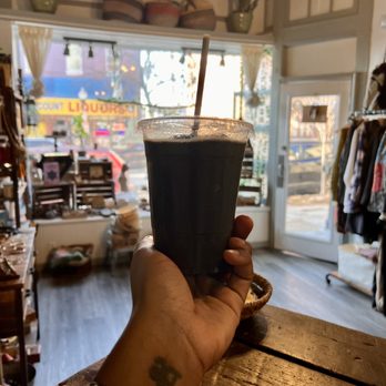 The Green House Juice Cafe - a hand holding a cup of coffee - Vegan Near Me - Baltimore, Maryland The Green House Juice Cafe - a hand holding a cup of coffee - Vegan Near Me - Baltimore, Maryland