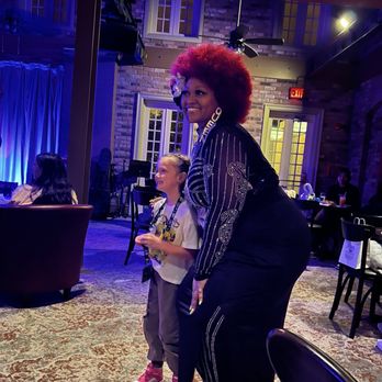 Scat Cat's Club - Lounge - Taking a photo with one of her adorable admirers - Themed Cafes Near Me - Lake Buena Vista, Florida