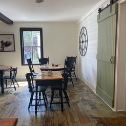 a dining room with a table and chairs