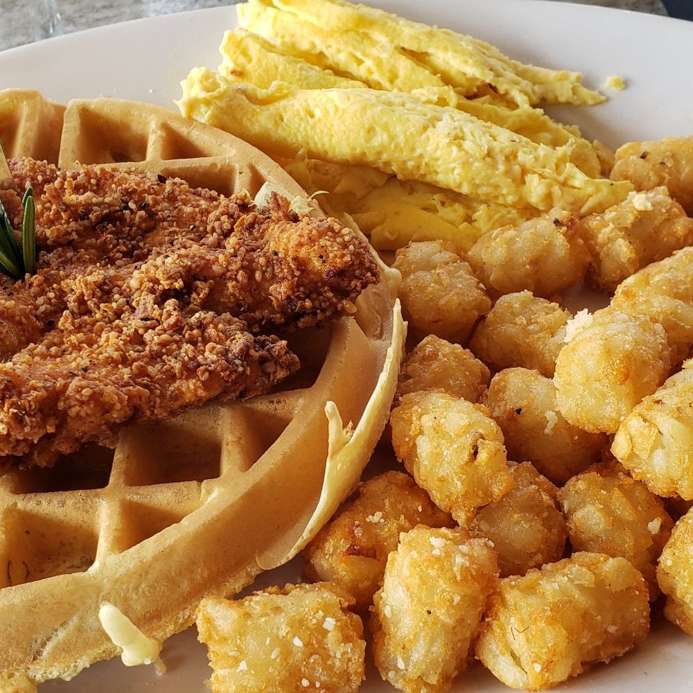 Bay Local Eatery - Chicken on top of a chocolate chip waffle with scrambled eggs and tater tots. (The chocolate chips were an upcharge, but worth it!) - New American Near Me - Virginia Beach, Virginia Bay Local Eatery - Chicken on top of a chocolate chip waffle with scrambled eggs and tater tots. (The chocolate chips were an upcharge, but worth it!) - New American Near Me - Virginia Beach, Virginia